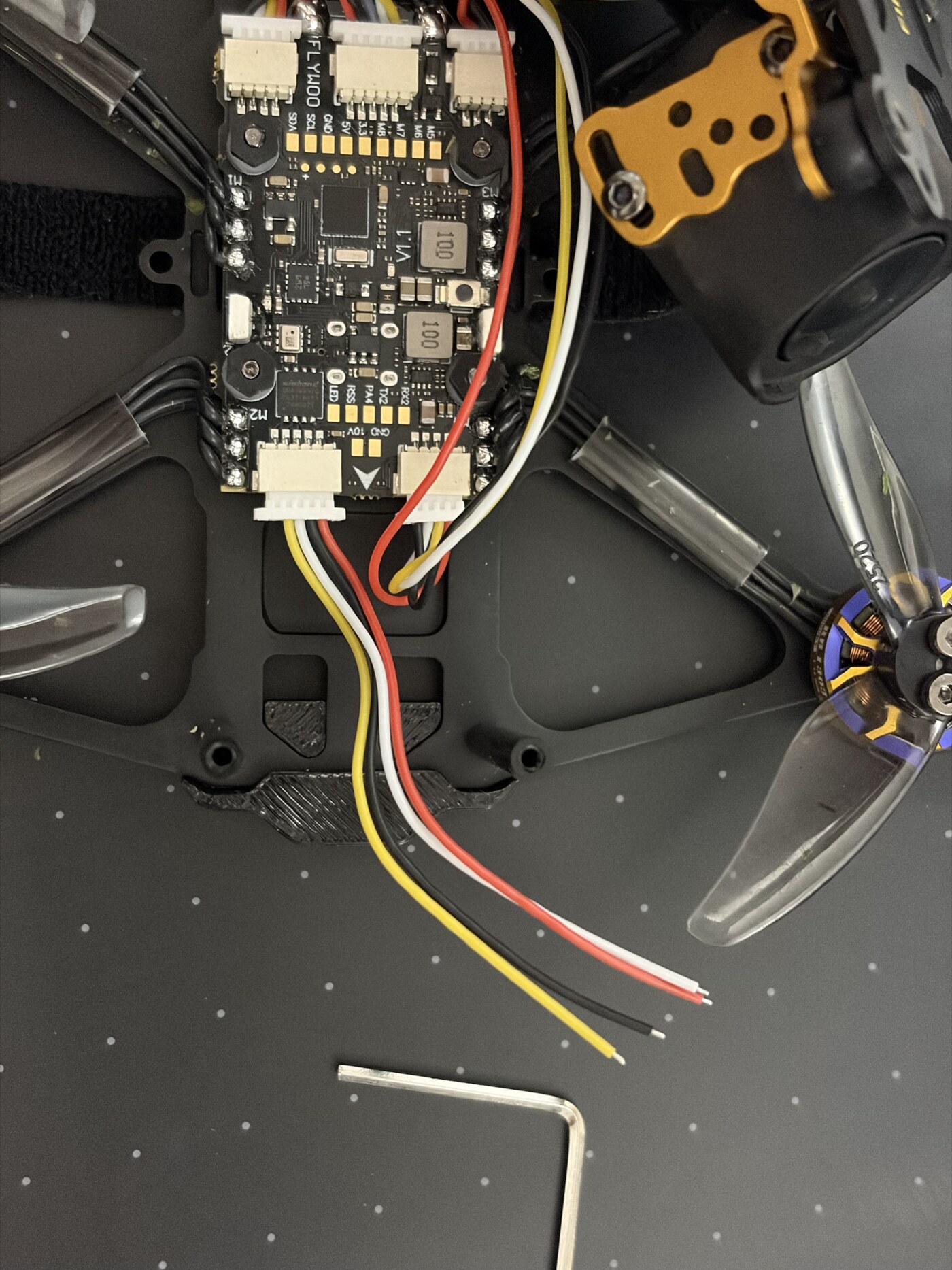 Flywoo flight controller with four-wire harness fitted in its five-position UART1 socket